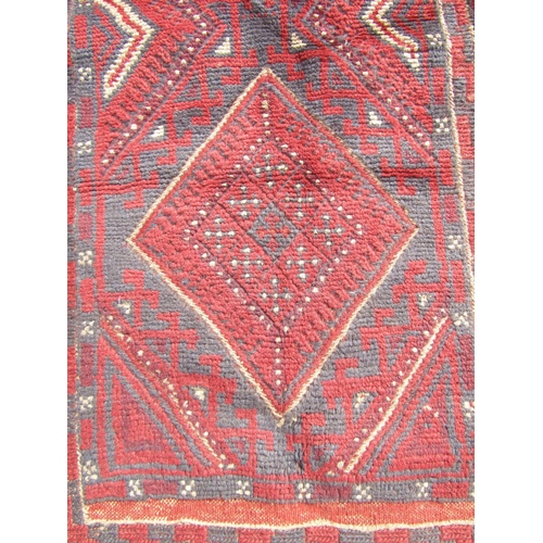 2510 - A Meshwani Runner with repeated central diamond design in tones of alizarin crimson and violet blue,... 