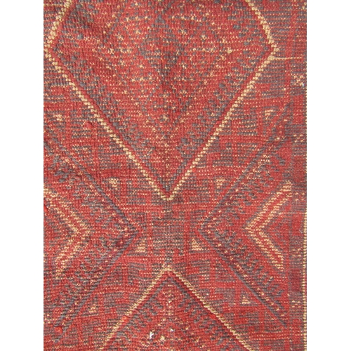 2510 - A Meshwani Runner with repeated central diamond design in tones of alizarin crimson and violet blue,... 