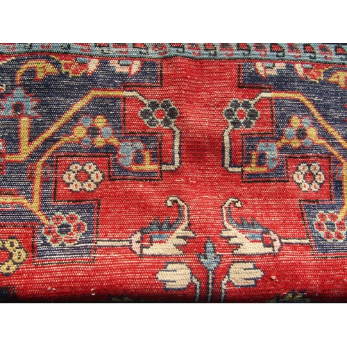 2511 - A North West Persian Tafresh Rug with central medallion and symmetrical flora and fauna design on a ... 