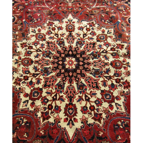 2514 - A Large Persian Bakhtiari Rug with shah abbas design in tones of crimson, indigo and natural wool wi... 