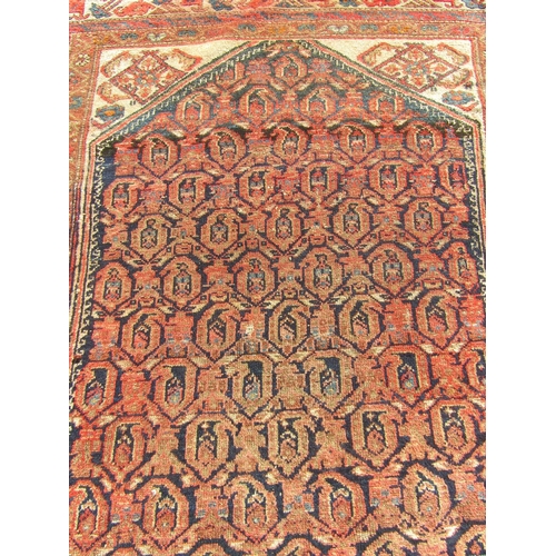 2521 - An old Persian Hamadan rug with central boteh design on an indigo field and animal motif corner brac... 