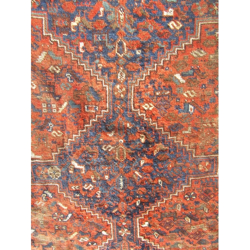 2529 - A Middle Eastern rug with three central medallions and animal motifs, hand-knotted wool on wool in t... 