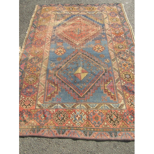 2532 - A Middle Eastern low-pile rug with two diamond medallions on a cobalt ground and a border of lobed a... 