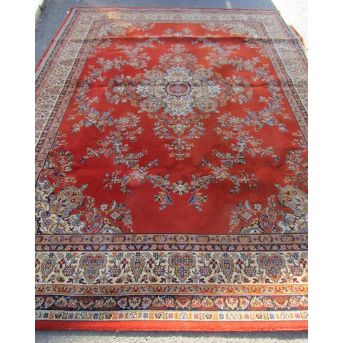 2534 - A large Wilton Kashan wool carpet with a central floral medallion on a burnt orange ground, 364cm x ... 