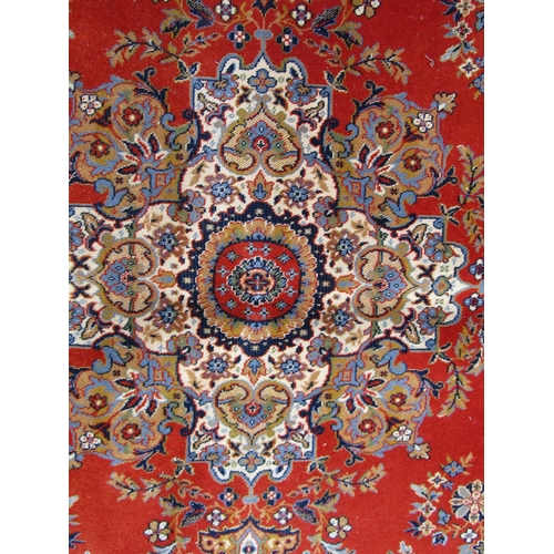 2534 - A large Wilton Kashan wool carpet with a central floral medallion on a burnt orange ground, 364cm x ... 