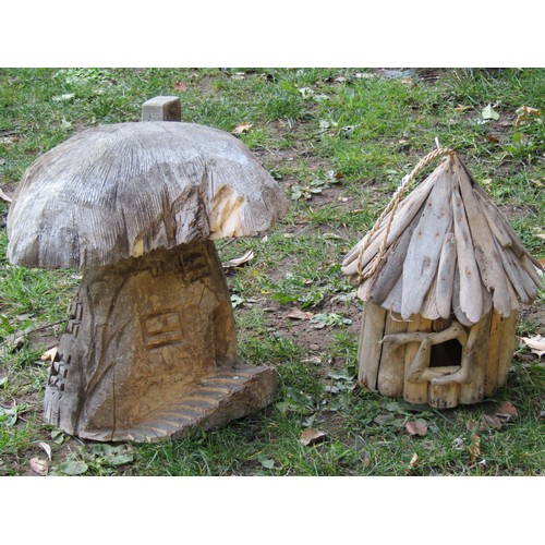 2030 - A small novel rustic hanging bird box, 32 cm high, together with a small carved toadstool shaped fai... 