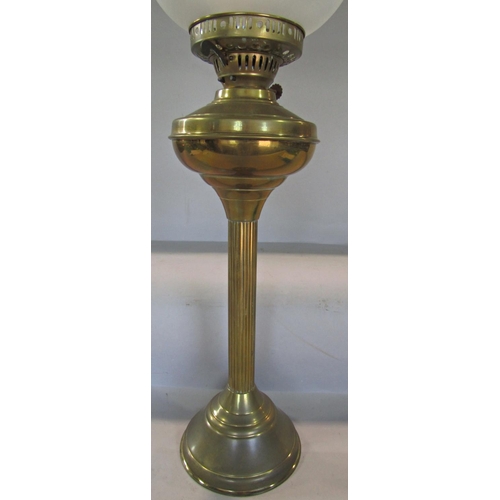 1704 - A 19th century brass reeded column oil lamp, with a semi opaque glass shade and chimney, 70cm high a... 