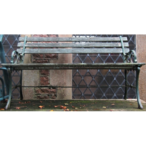 2010 - A pair of two seat garden benches with decorative cast iron end supports with open scroll detail (af... 