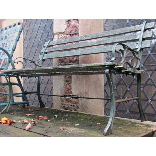 2010 - A pair of two seat garden benches with decorative cast iron end supports with open scroll detail (af... 