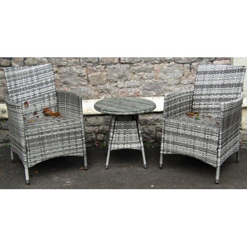 2026 - A pair of contemporary synthetic all weather woven cane style garden chairs and matching table with ... 