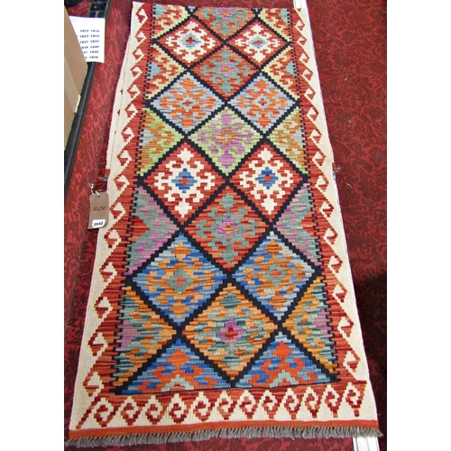 2542 - A Chobi Kilim Runner with geometric burdock diamond design and hooked border in multicoloured tones,... 