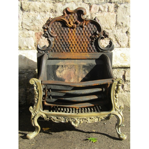 2017 - An antique style cast iron and brass fire basket with scrolling acanthus and further decorative deta... 