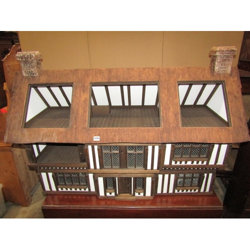 2284 - A contemporary dolls house in the form of a mock Tudor manor with simulated thatched roof, together ... 