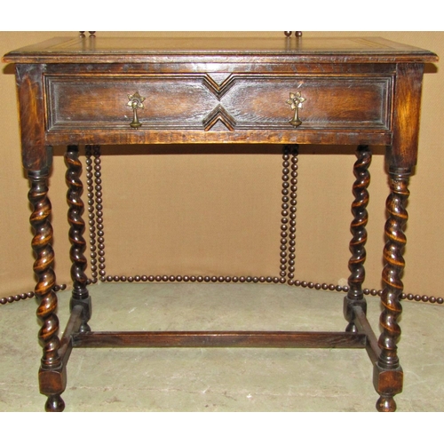 2298 - A small Jacobean revival oak writing table with inset leather top over two drawers on barley twist l... 