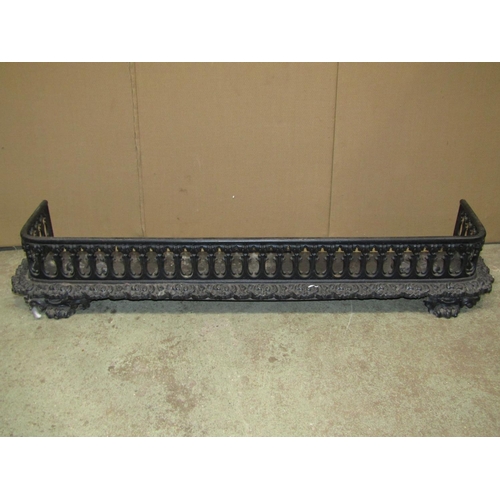 2316a - A Victorian cast iron fender with repeating pierced grille and foliate detail, 136cm wide, together ... 