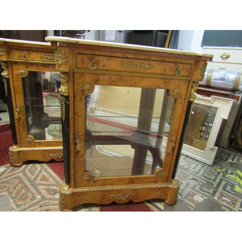 2454 - A matched pair of reproduction side/pier cabinets with applied gilt metal mounts, each enclosed by a... 