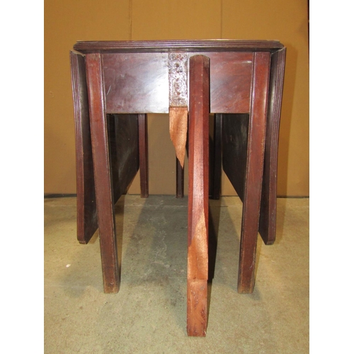 2460 - A 19th century mahogany drop leaf dining table raised on six square cut and moulded supports (af)