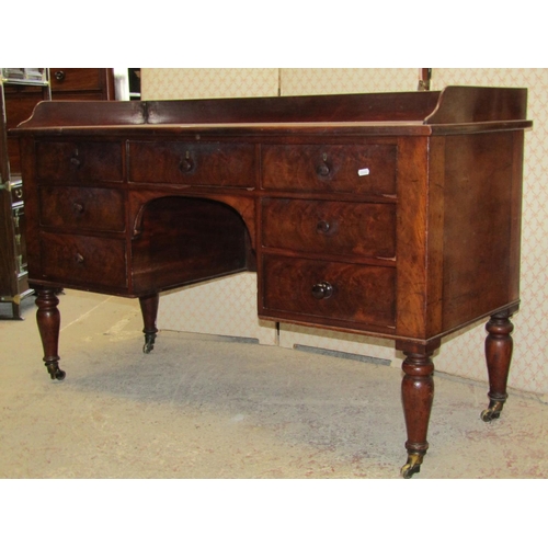 2602 - A mid-Victorian mahogany side table, the central kneehole surrounded by an arrangement of seven draw... 