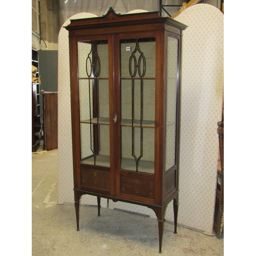 2605 - A full height Edwardian display cabinet, with glazed front and sides upon four delicate supports wit... 