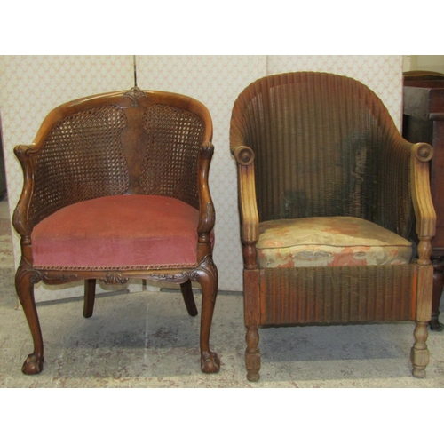 2610 - A pair of 1930s walnut framed tub chair with double Bergere panels and upholstered seat on claw and ... 