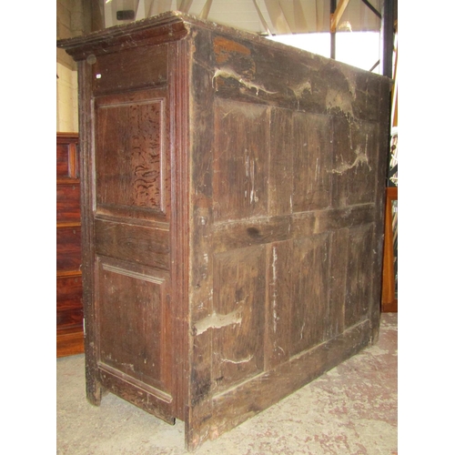 2613 - A 18th century oak cupboard enclosed by three panelled doors and further panels, with steel fittings... 