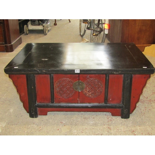 2618 - A low Chinese table of rectangular form with ebonised and stained finish and incorporating a cupboar... 