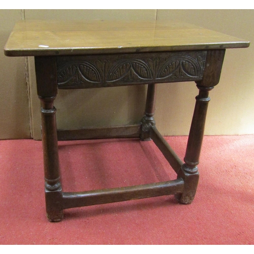 2687A - A small 18th century oak occasional table raised on four gun barrel supports, with single carved rep... 