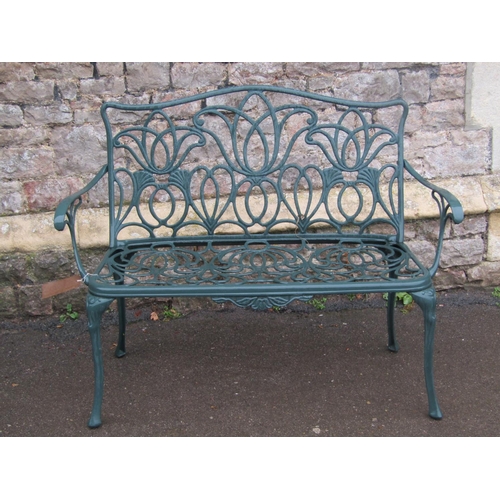 2025a - A contemporary cast aluminium green painted two seat garden bench with decorative pierced and scroll... 