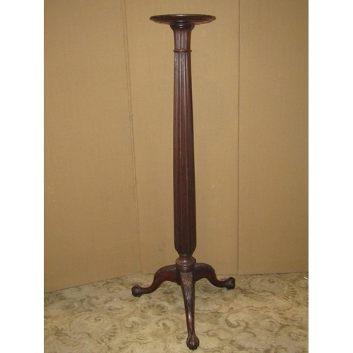 2403 - A Georgian style mahogany torchere with reeded column