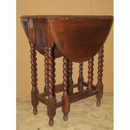 2429 - A small 1920's oak drop leaf barley twist gateleg table together with a further barley twist standar... 