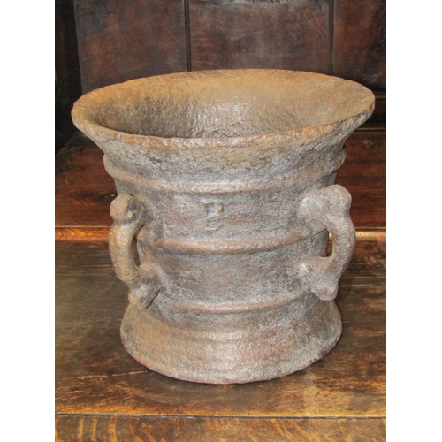 2777 - Antique cast iron mortar with four scrolled loop handles 25cm in d x 22cm h