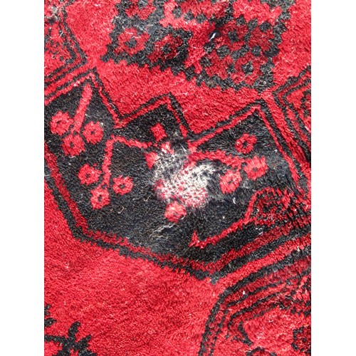 2546 - A large country house carpet, central running medallions within alternating running borders on a red... 