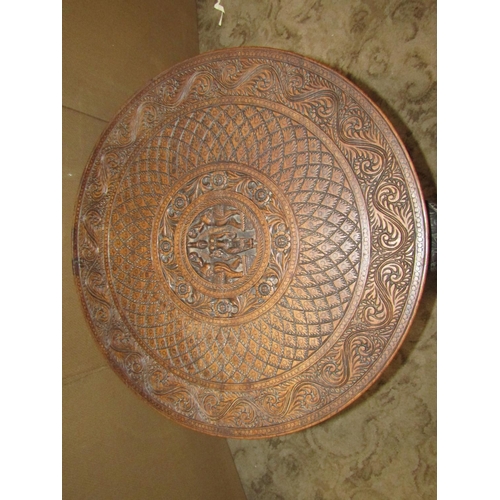 2431 - A Indian circular occasional table with profusely carved detail raised on three elephant head and tr... 