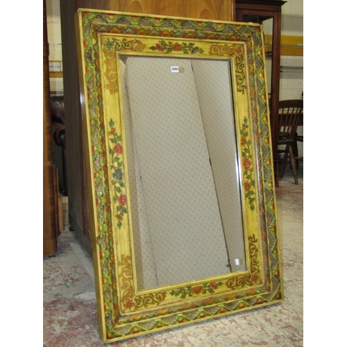 2593 - A Chinese wall mirror, the lacquered framework with repeating floral detail, 1m x 80cm