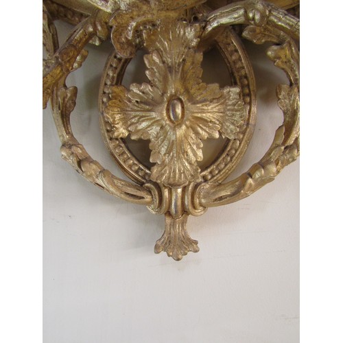 2662a - An early 19th century gilt framed wall mirror of oval form, the decorative gilt frame with repeating... 