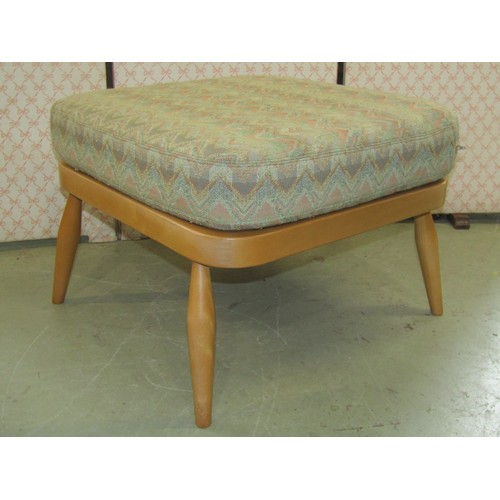 2645 - A light Ercol three seat stick-back sofa with two matching armchairs and a stool (4)