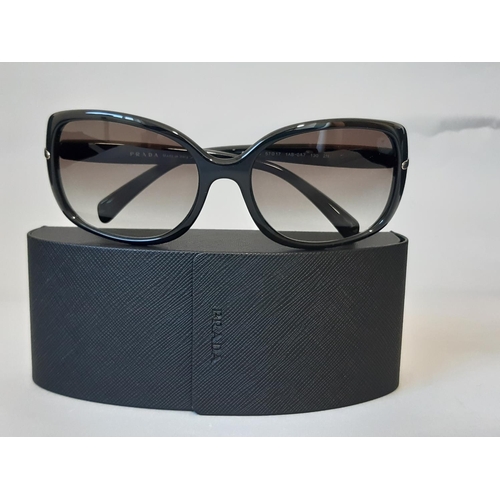 1622 - One pair ladies sunglasses by Prada, unused with original hard case, sealed cleaning cloth and card ... 