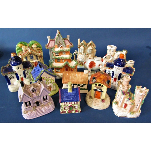 1093 - A collection of 19th century and later Staffordshire cottages and castle including a lilac version, ... 