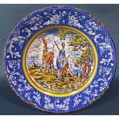 1009 - A 19th century continental tin glazed plate showing Don Quixote in landscape, a further tin glazed e... 