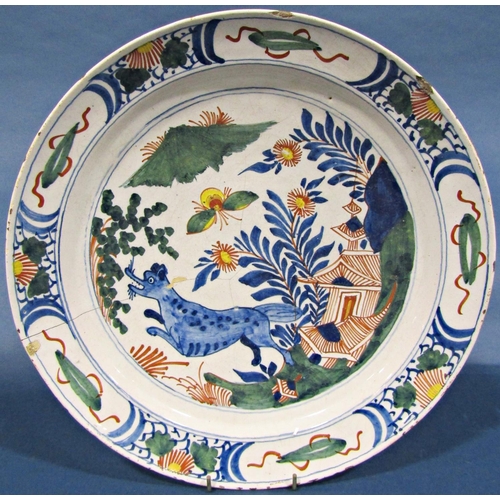 1054 - A late 18th century blue and white tin glazed plate with chinoiserie garden detail within a repeatin... 