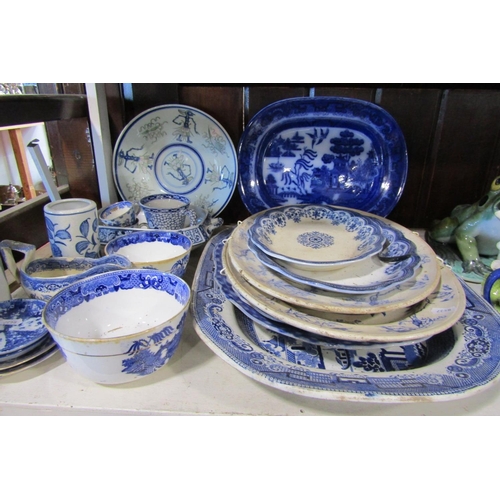 1124 - A collection of 19th century and other blue and white transfer printed ware to include graduated mea... 