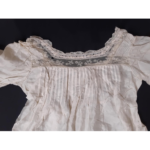 1615 - Four late 19th/ early 20th century garments including the following; full length ivory silk dress wi... 