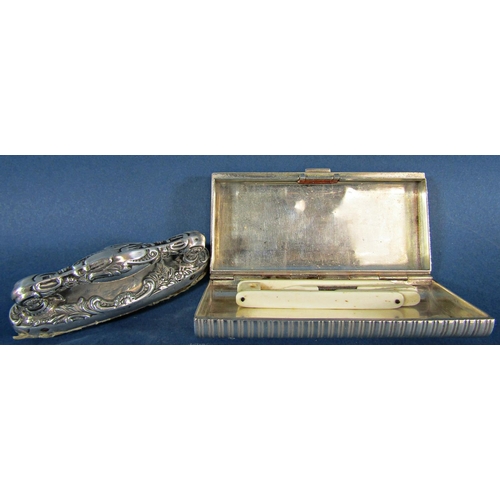 1210A - A silver rectangular box, stamped 925, a silver nail buffer, an iridescent shell dressing table stan... 