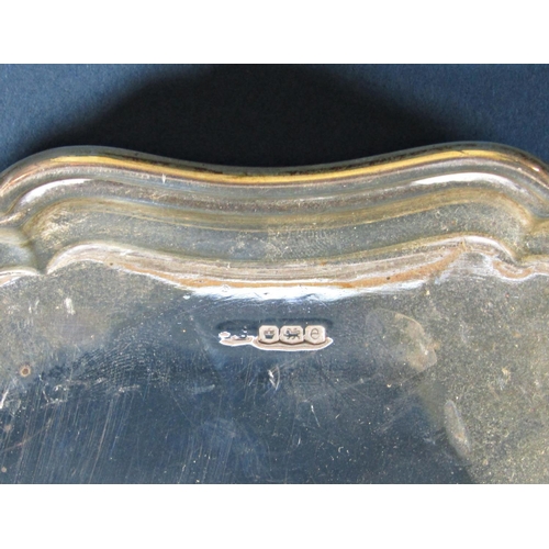 1238 - A silver scalloped edge tray raised on four pad feet, Sheffield 1922, maker Stevenson & Law, 25.5cm ... 