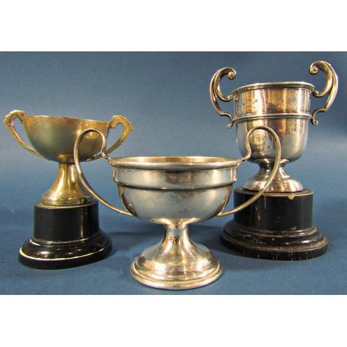 1246 - Three small silver trophies with a single napkin ring, 4.6oz including one trophy base