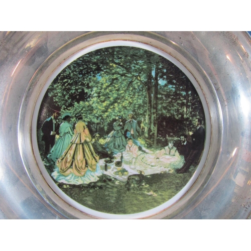 1257 - A silver dish stamped 925 to the back with Renoirs Dejuner sur L'Herbe, china inset base, 20.5cm dia... 