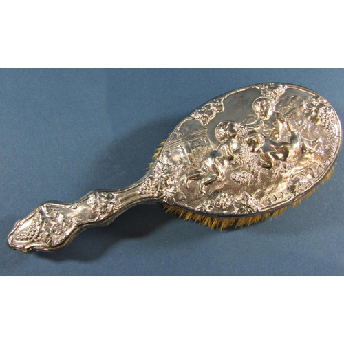 1269 - A silver backed hairbrush with a Bacchanalian decoration, a silver pepper grinder and a silver cappe... 