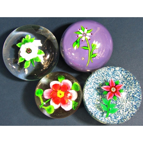 1150 - A collection of seven paperweights, including a Perthshire single flower signed P to a cane, a Caith... 