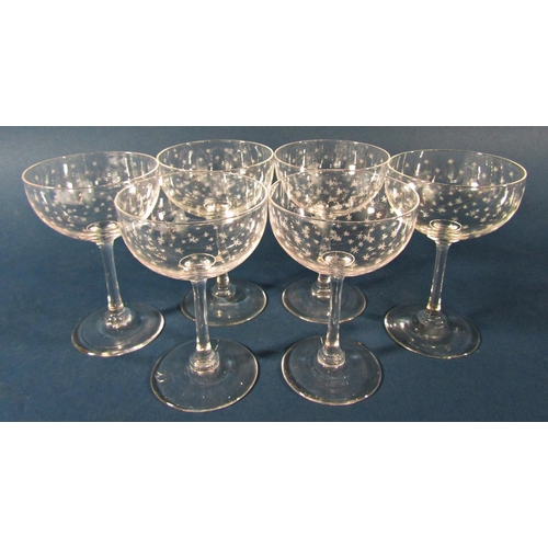 1161 - Twelve star etched Champagne bowls, four Champagne bowls with facetted stems and three Champagne bow... 