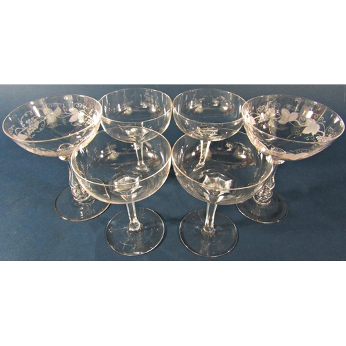 1161 - Twelve star etched Champagne bowls, four Champagne bowls with facetted stems and three Champagne bow... 